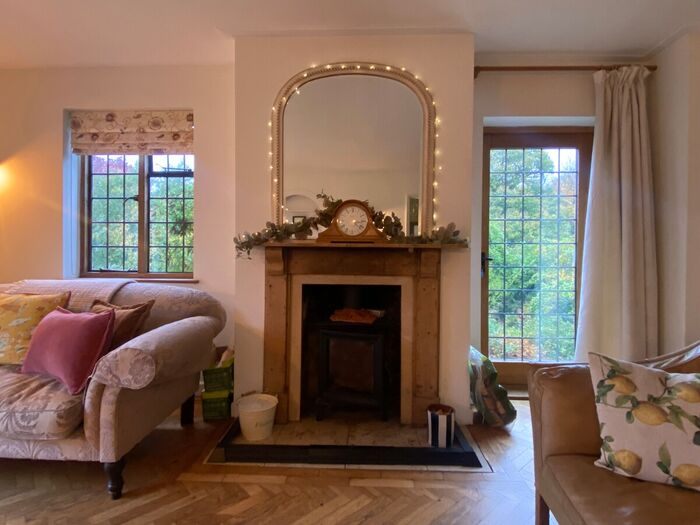 A cosy sitting room with an open fireplace